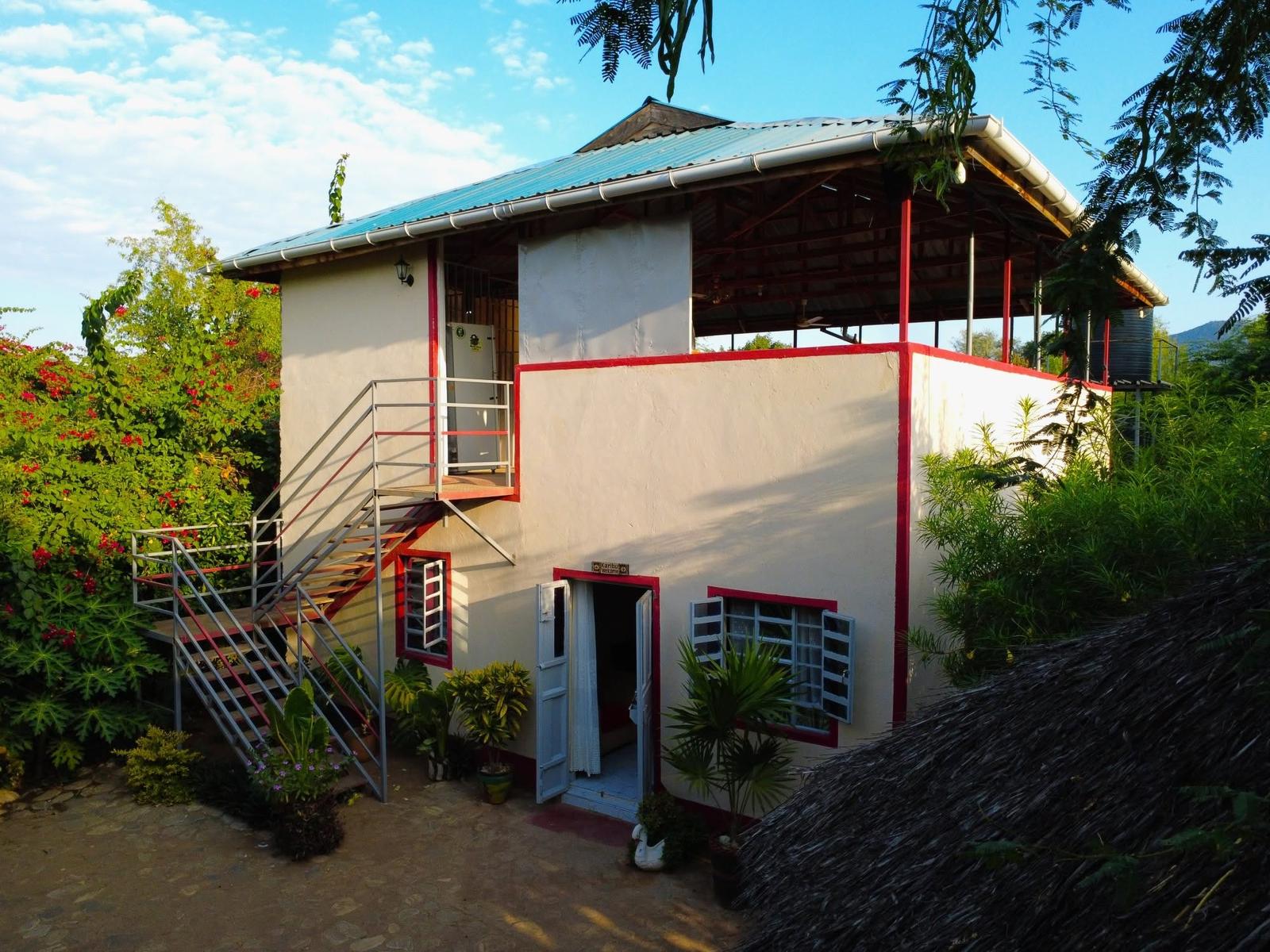 The Loita House exterior in morning light, doors open onto the courtyard