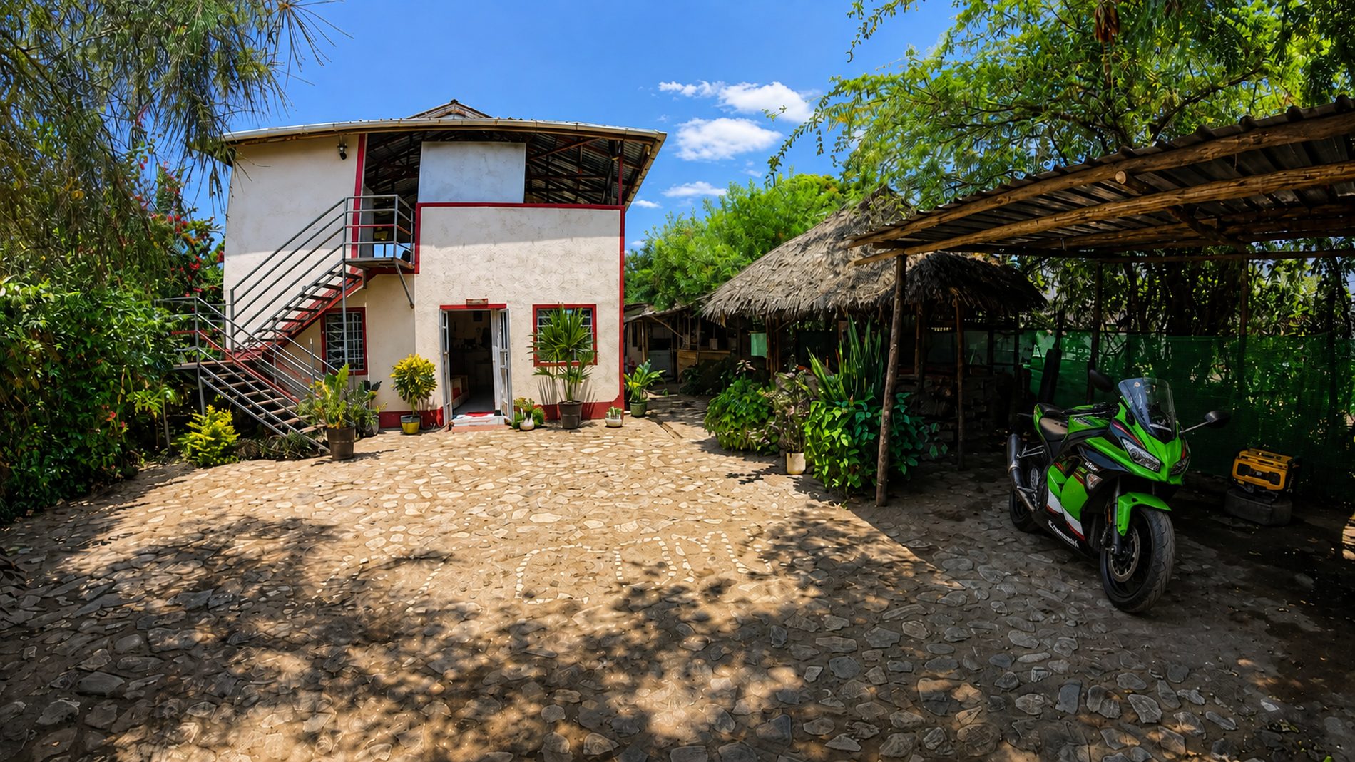 The main house at Nguruman Waterfront Resort, with the guest stairway and thatched shelter