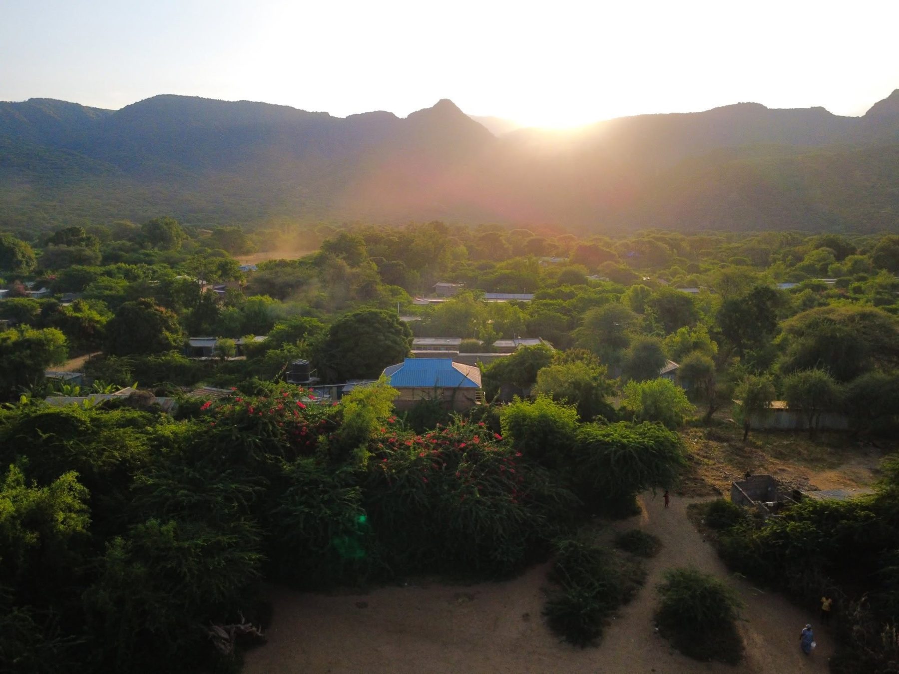 Aerial view of Nguruman Waterfront Resort at sunset beneath the escarpment